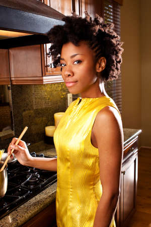 African American woman cooking in the kitchen.の写真素材