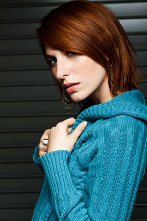 Beautiful young woman in a blue sweater.の写真素材