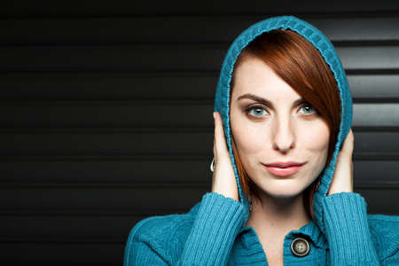 Beautiful young woman in a blue sweater.の写真素材