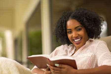 African American woman studing and reading the Bible.