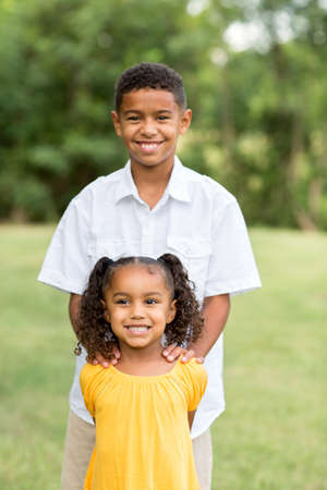 Portrait of a big brother and his little sister.の写真素材