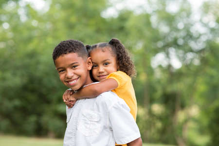 Portrait of a big brother and his little sister.の写真素材