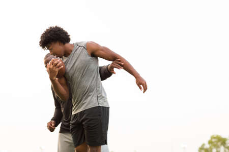 American Football coach training a young athlete.