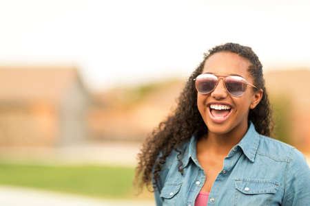 Portriat of a young teenage girl laughing.の写真素材