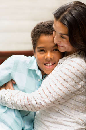 Portrait of a loving mom hugging her son.