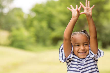 Cute mixed race little girl laughing and smiling.の写真素材