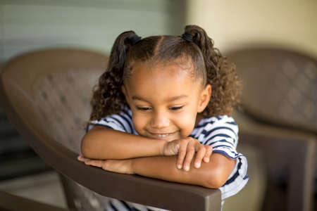 Cute mixed race little girl laughing and smiling.の写真素材