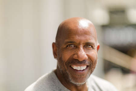 Happy mature African American man smiling outside.の写真素材