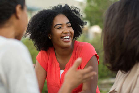 Diverse group of friends talking and laughing.の写真素材