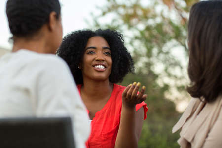 Diverse group of friends talking and laughing.の写真素材