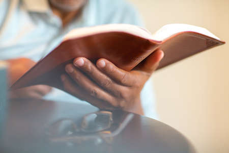 African American man praying and reading the Bible.の写真素材
