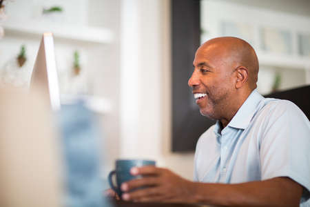 Mature African American man working from his home office.の写真素材