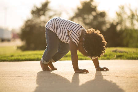 Happy little girl laughing and smiling outside.の写真素材