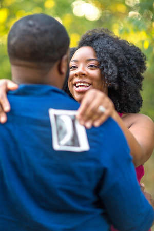 Portrait of a happy pregnant African American couple.の写真素材