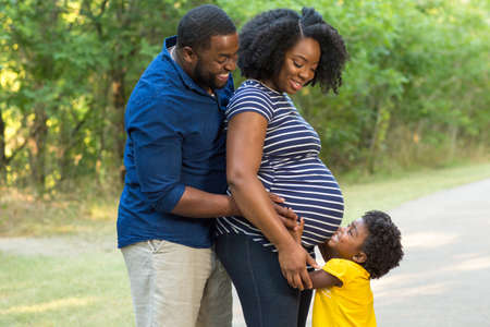 Portrait of a pregnant African American family.の写真素材