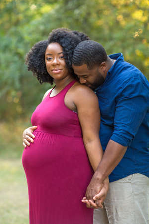 Portrait of a happy pregnant African American couple.の写真素材