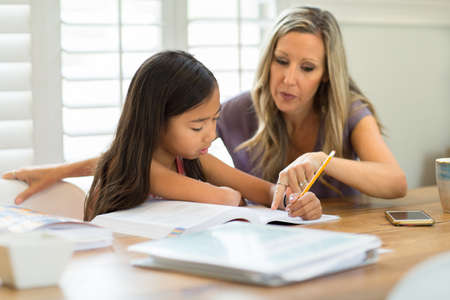 Teacher Helping Her Student With Her Homeworkの写真素材
