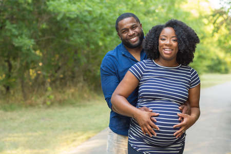 Portrait of a happy pregnant African American couple.の写真素材