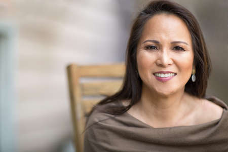 Happy mature Asian woman laughing and smiling.の写真素材