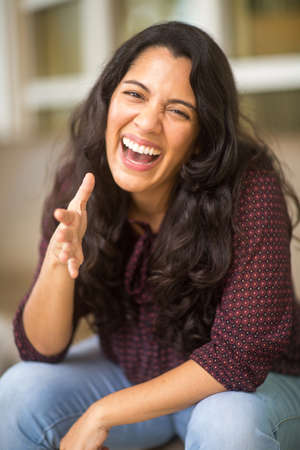 Confident Hispanic woman laughing and smiling stock photoの写真素材