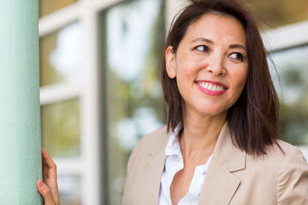 Portrait of a confident Asian businesswoman smiling.の写真素材
