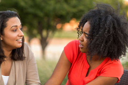 Diverse group of friends talking and laughing.の写真素材