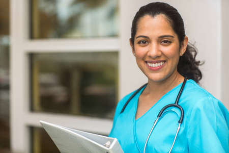 Happy Hispanic medial provider at work stock photo.の写真素材