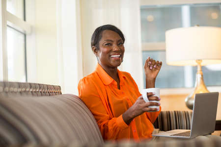 Mature older woman on her computer working from home.の写真素材