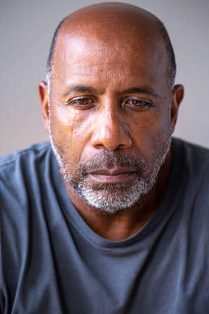 Portrait of a mature man looking sad and away from the camera.の写真素材