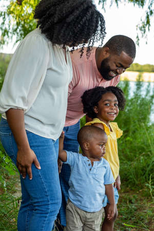 Happy African American family outside at a park.の写真素材