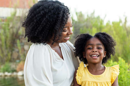 Happy mother and her beautiful daughter smiling.の写真素材