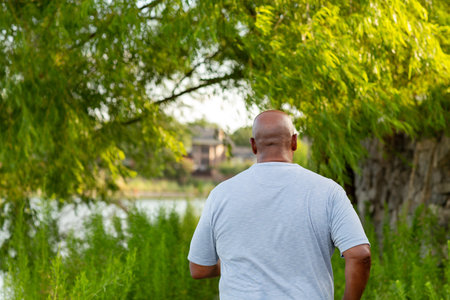 Rear view of a mature man walking and getting exerciseの写真素材