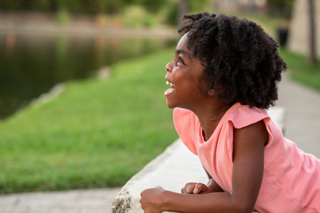 Happy African Amerian little girl smiling outside.の写真素材