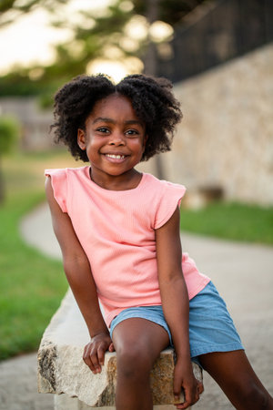 Happy African Amerian little girl smiling outside.の写真素材