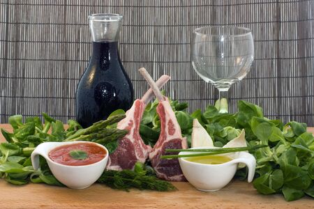 a ready to cook food composition with rack of lambs and other ingredientsの写真素材