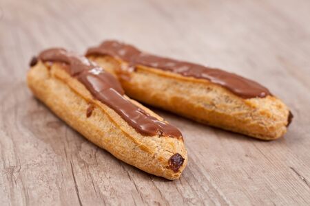 Sweet chocolate pastry on wooden background