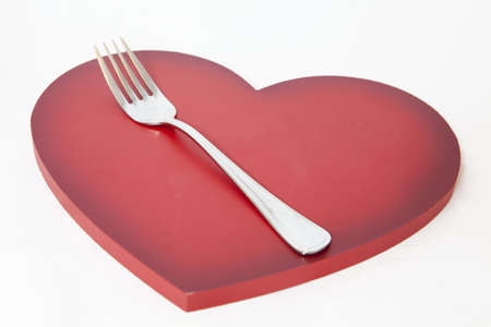 Metal fork on a valentine's heartの写真素材