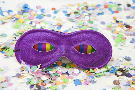 Colorful carnival background with stripes and mask