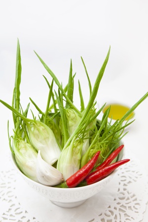 cup of fresh chicory, red pepper and oilの写真素材