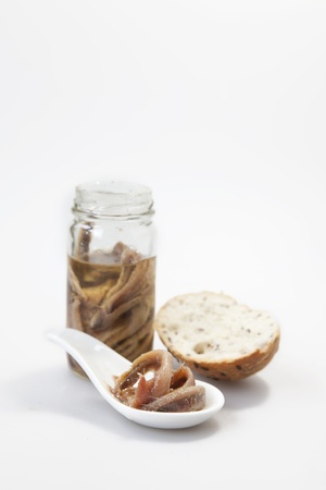Delicious salted anchovies with oil on white backgroundの写真素材