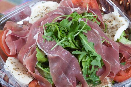 Delicious salad with Parma Ham, arugula and mozzarella cheeseの写真素材