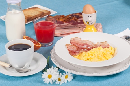 Breakfast with scrambled eggs and crispy bacon