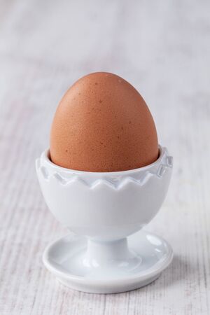 Boiled egg served on elegant white cupの写真素材