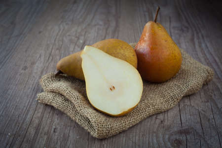 Bunch of fresh pears on a wooden backgroundの写真素材