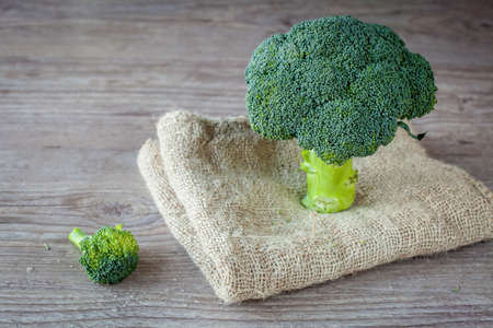 Bunch of fresh green broccoli on wooden backgroundの写真素材
