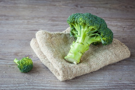 Bunch of fresh green broccoli on wooden backgroundの写真素材