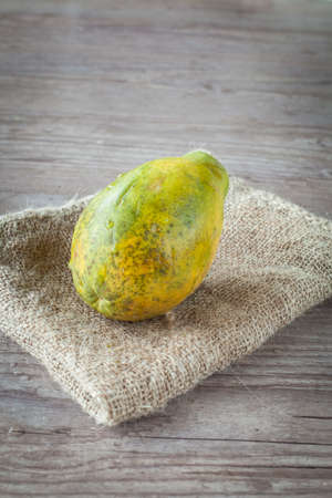Fresh papaya fruit on wooden backgroundの写真素材