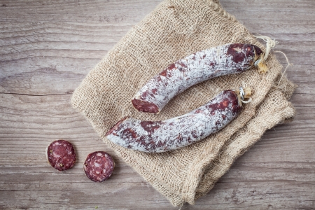 Fresh and delicious donkey salami on wooden backgroundの写真素材