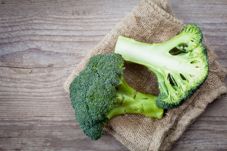 Bunch of fresh green broccoli on wooden backgroundの写真素材