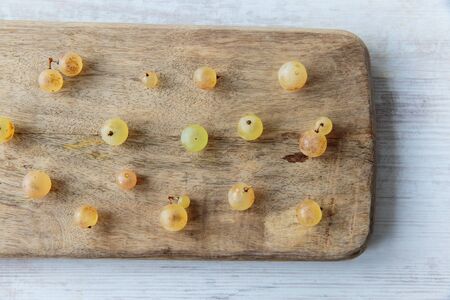 Fresh white whine grapes on a chopping boardの写真素材